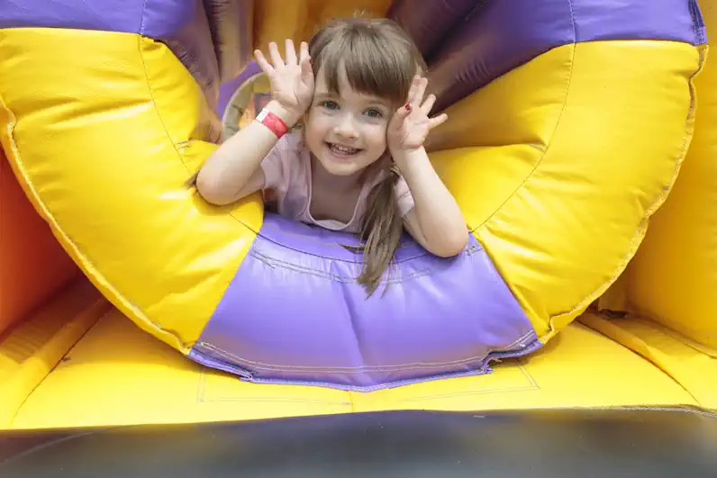 Young Child Smiling in Bouncy House